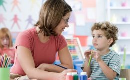 Ребенок рисует с учительницей - фото