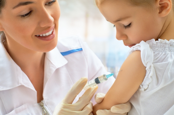 Доктор делает прививку маленькой девочке