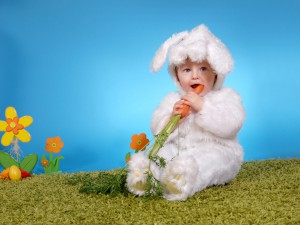 Маленький ребенок в костюмчике зайчика, с морковкой - фото