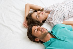 Пара спит в постели - фото