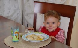 Маленькая девочка за обеденным столом - фото