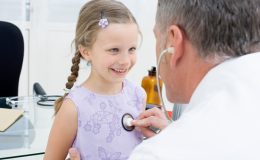 Доктор прослушивает маленькую девочку - фото