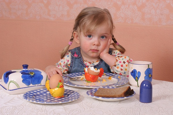 Девочка за обеденным столом - фото
