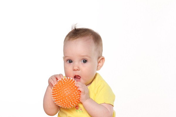 Грудной ребенок с мячиком - фото