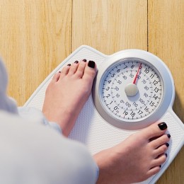 Woman standing on weight scales