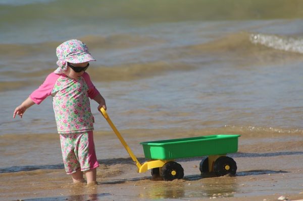 ребенок играет на пляже